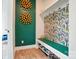 Inviting foyer with a unique accent wall, patterned wallpaper, and built-in storage at 2533 Ensemble Ct, Charlotte, NC 28262