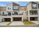 Modern townhouse with garage, driveway, upper level balcony, and neutral colored exterior siding and architectural design at 2533 Ensemble Ct, Charlotte, NC 28262
