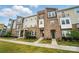 Well-maintained townhomes with stone accents, landscaping, and individual entrances at 2533 Ensemble Ct, Charlotte, NC 28262
