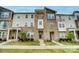 Beautiful three-story townhome featuring stone accents and manicured landscaping at 2533 Ensemble Ct, Charlotte, NC 28262