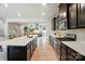 Open kitchen with dark cabinets and island, seamlessly connected to the living area for modern living and entertaining at 2533 Ensemble Ct, Charlotte, NC 28262