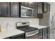 Modern kitchen showcasing stainless steel appliances, sleek countertops, and stylish dark cabinetry for a chef-inspired space at 2533 Ensemble Ct, Charlotte, NC 28262