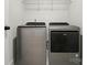 Laundry room featuring gray Whirlpool washer and dryer with white wire shelving at 2533 Ensemble Ct, Charlotte, NC 28262