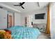 Cozy main bedroom showcasing ceiling fan, TV, dresser and adjoining ensuite bathroom at 2533 Ensemble Ct, Charlotte, NC 28262