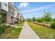 Scenic street view showcasing well-kept townhomes, lush landscaping, and inviting community ambiance at 2533 Ensemble Ct, Charlotte, NC 28262