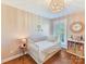 Charming bedroom with a white crib, light fixture and bright window at 2621 Huntman Way, Charlotte, NC 28226