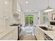 Bright kitchen features white cabinetry, stainless appliances, and a view to an outdoor deck at 2621 Huntman Way, Charlotte, NC 28226