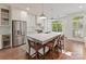 Bright kitchen featuring a large center island with barstool seating, stainless appliances, and an abundance of natural light at 2621 Huntman Way, Charlotte, NC 28226