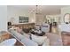 Open concept living room featuring modern furniture, a decorative fireplace, and seamless flow to the kitchen and dining area at 2621 Huntman Way, Charlotte, NC 28226