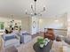 Open concept living room featuring modern furniture, an iron railing, and seamless flow to the kitchen and dining area at 2621 Huntman Way, Charlotte, NC 28226