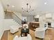 Inviting living room with hardwood floors, modern chandelier and open concept to kitchen at 2621 Huntman Way, Charlotte, NC 28226