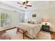 Comfortable main bedroom with a tray ceiling, neutral decor and light-filled windows at 2621 Huntman Way, Charlotte, NC 28226