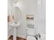 Bright half bath features a pedestal sink, white fixtures and tasteful wall art at 2621 Huntman Way, Charlotte, NC 28226