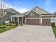 Charming two-story home with three-car garage and well-manicured lawn in a desirable neighborhood at 291 Preston Rd, Mooresville, NC 28117