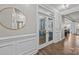 Beautiful hallway leading to a stylish office with glass doors and views of the rest of the home at 291 Preston Rd, Mooresville, NC 28117