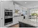 A modern kitchen features white cabinets, granite countertops, and stainless steel appliances at 291 Preston Rd, Mooresville, NC 28117
