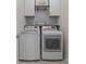Well-organized laundry room with white cabinets, shelving, and modern washer and dryer at 291 Preston Rd, Mooresville, NC 28117