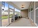Screened patio with fan and a view of the backyard and white fence at 291 Preston Rd, Mooresville, NC 28117