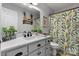 Bright bathroom features a white vanity, modern fixtures, and vibrant floral shower curtain at 4808 Thoreau Dr, Conover, NC 28613