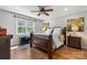 Well-lit bedroom with hardwood floors, a ceiling fan, large window, and warm inviting decor at 4808 Thoreau Dr, Conover, NC 28613