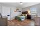 Cozy bedroom featuring hardwood floors, a window, and fun dinosaur themed decor at 4808 Thoreau Dr, Conover, NC 28613