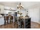 Inviting dining area featuring a rustic table set, modern lighting fixtures, and an open view of the kitchen at 4808 Thoreau Dr, Conover, NC 28613