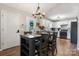 Cozy dining area with a stylish table set, modern lighting, and a view of the well-equipped kitchen at 4808 Thoreau Dr, Conover, NC 28613