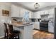 Bright kitchen features white cabinets, granite countertops, a stylish light fixture, and hardwood flooring at 4808 Thoreau Dr, Conover, NC 28613
