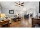 Open-concept living room and kitchen featuring hardwood floors, vaulted ceilings, and modern lighting fixtures at 4808 Thoreau Dr, Conover, NC 28613