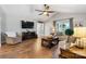 Bright living room featuring hardwood floors, a ceiling fan, a fireplace, and comfortable seating at 4808 Thoreau Dr, Conover, NC 28613