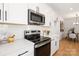 Well-equipped kitchen with modern appliances, white cabinetry, subway tile backsplash, and a cozy dining nook at 4819 Victoria Ave, Charlotte, NC 28269