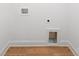 Bright laundry room with wood-look flooring and modern hookups ready for washer and dryer installation at 4819 Victoria Ave, Charlotte, NC 28269