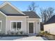 Charming single story home with neutral siding and a decorative wreath on the front door at 4821 Victoria Ave, Charlotte, NC 28269