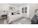 Serene bedroom featuring neutral tones, soft lighting, and a large window at 4827 Victoria Ave, Charlotte, NC 28269