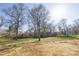 Expansive backyard with lush green grass and mature trees, offering plenty of space at 4907 Victoria Ave, Charlotte, NC 28269
