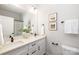 Modern bathroom featuring double sinks, quartz counters and black fixtures at 4907 Victoria Ave, Charlotte, NC 28269