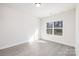 Sunlit bedroom with modern flooring is a blank canvas for customization at 4907 Victoria Ave, Charlotte, NC 28269