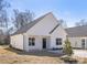 Charming single-story home with a bright white exterior, black front door, and well-manicured lawn at 4907 Victoria Ave, Charlotte, NC 28269