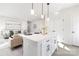 Bright, open-concept kitchen featuring a large island with seating and flows into the living area with modern furnishings at 4907 Victoria Ave, Charlotte, NC 28269