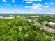 An aerial perspective of a home surrounded by lush greenery and mature trees in a suburban setting at 509 Carole Ln, Charlotte, NC 28214