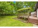 This back deck is surrounded by lush greenery and offers a view of the well-maintained yard at 509 Carole Ln, Charlotte, NC 28214