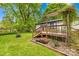 A charming back deck is complemented by a pergola and beautiful green landscaping at 509 Carole Ln, Charlotte, NC 28214