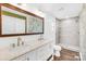 Bathroom with double sink vanity with modern hardware and a tiled stand up shower at 509 Carole Ln, Charlotte, NC 28214