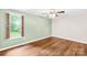 Cozy bedroom with hardwood floors, ceiling fan, and a window with natural light at 509 Carole Ln, Charlotte, NC 28214