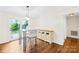 Cozy breakfast area with modern light fixture, glass top table and access to the outdoors at 509 Carole Ln, Charlotte, NC 28214