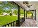 This covered front porch offers a view of the manicured front yard and surrounding neighborhood at 509 Carole Ln, Charlotte, NC 28214