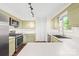 Kitchen with stainless steel appliances, light green cabinets, and bright countertops at 509 Carole Ln, Charlotte, NC 28214