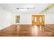 Spacious living room with laminate flooring, a large window, and a mirrored wall for added light and dimension at 509 Carole Ln, Charlotte, NC 28214