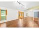 Bright living room with laminate flooring, window, and mirrored wall creates an airy and open atmosphere at 509 Carole Ln, Charlotte, NC 28214