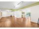 Bright and spacious living room with laminate flooring, large mirror, and open floor plan to the kitchen at 509 Carole Ln, Charlotte, NC 28214